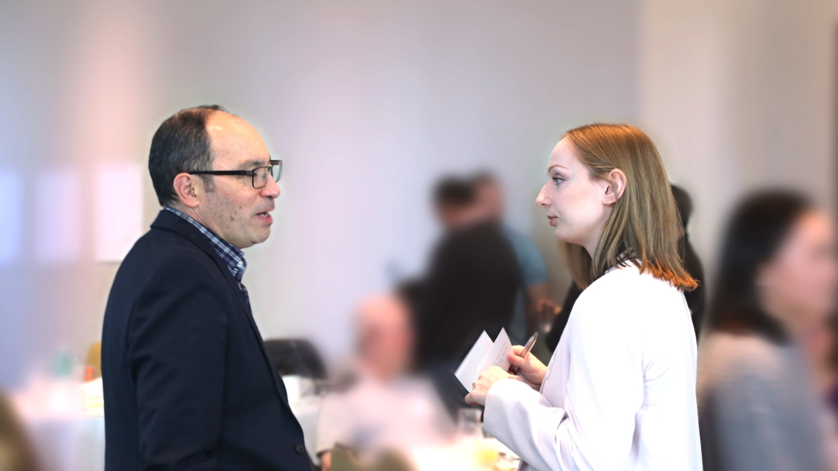 A REACH BC team member and event attendee speak at the Patient Partner Network Gathering.