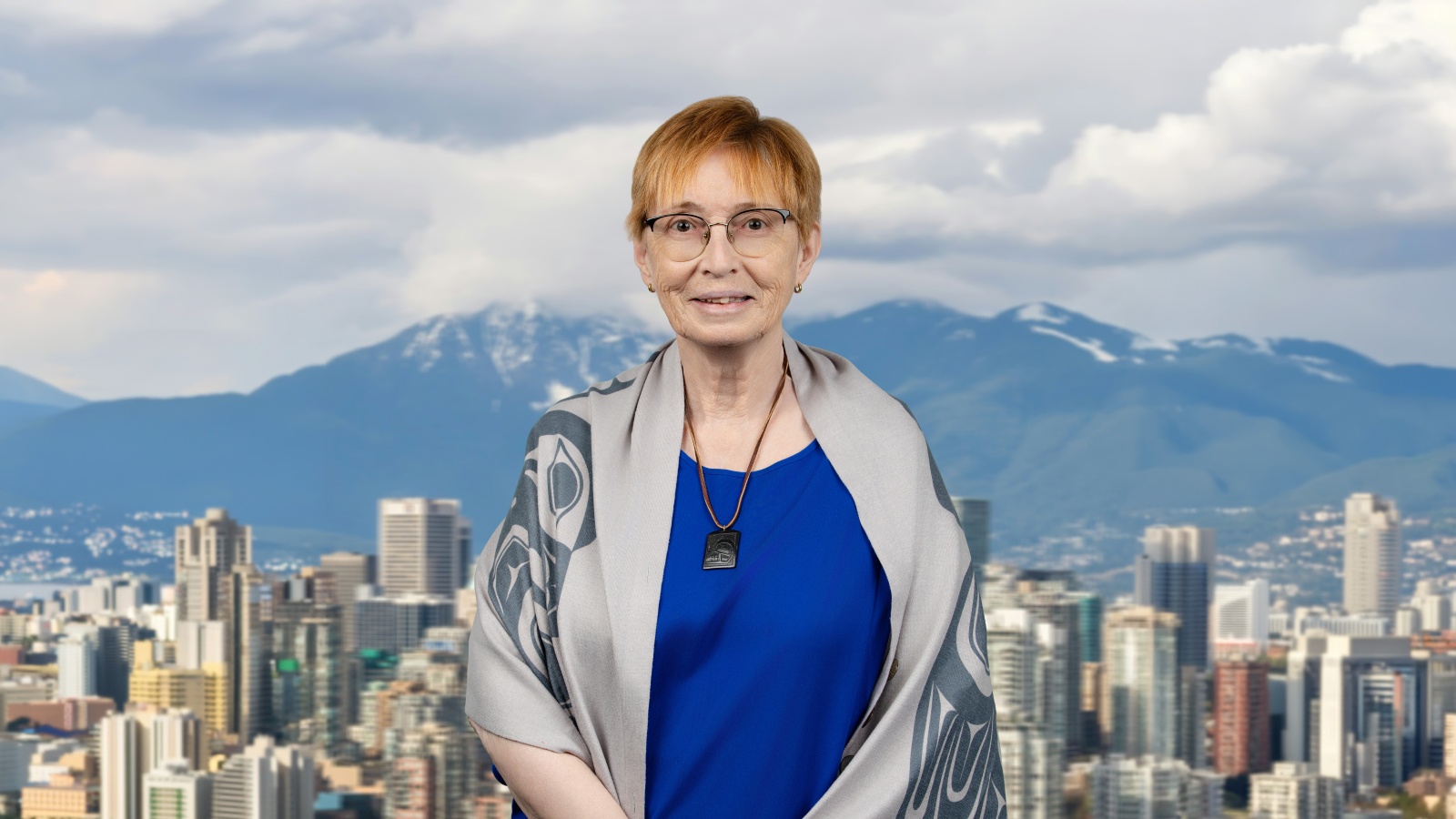 Dr. Barbara McGillivray smiling against a city skyline.